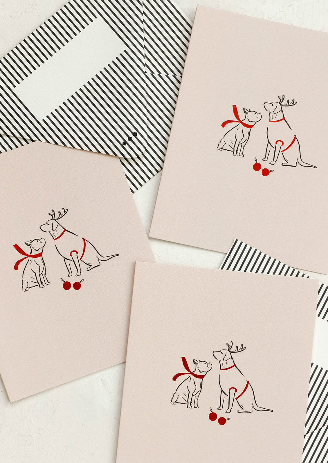 Pink greeting cards with illustration of two dogs wearing red scarves.