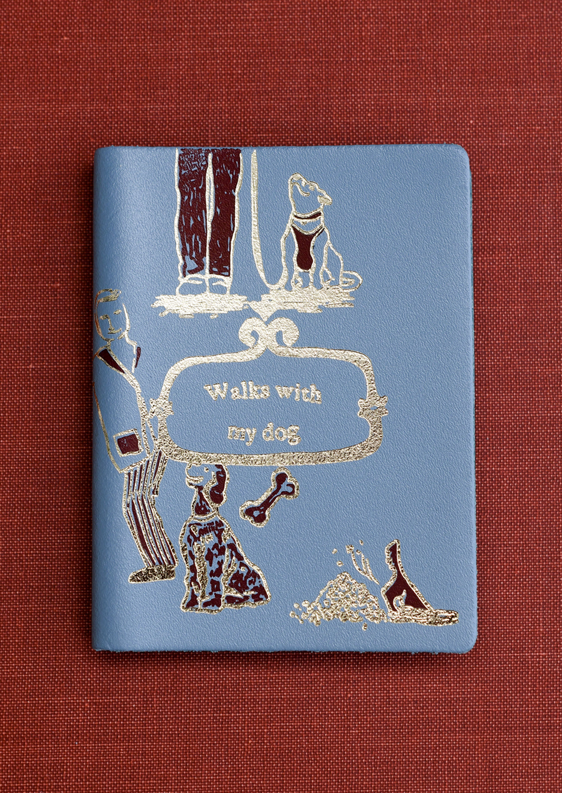 A blue notebook reading "Walks with my dog" on cover.