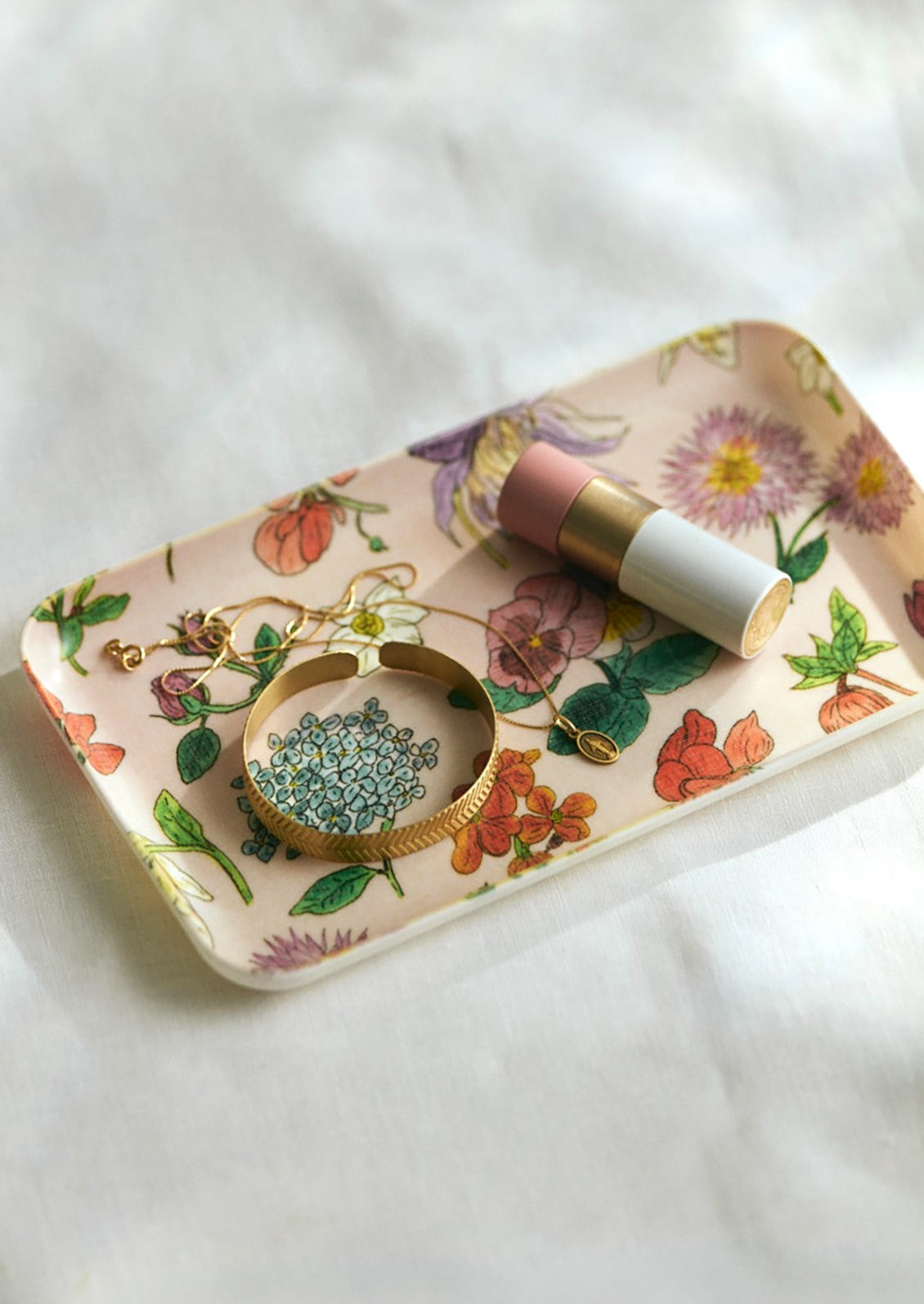 A multicolor floral print tray with pink background.