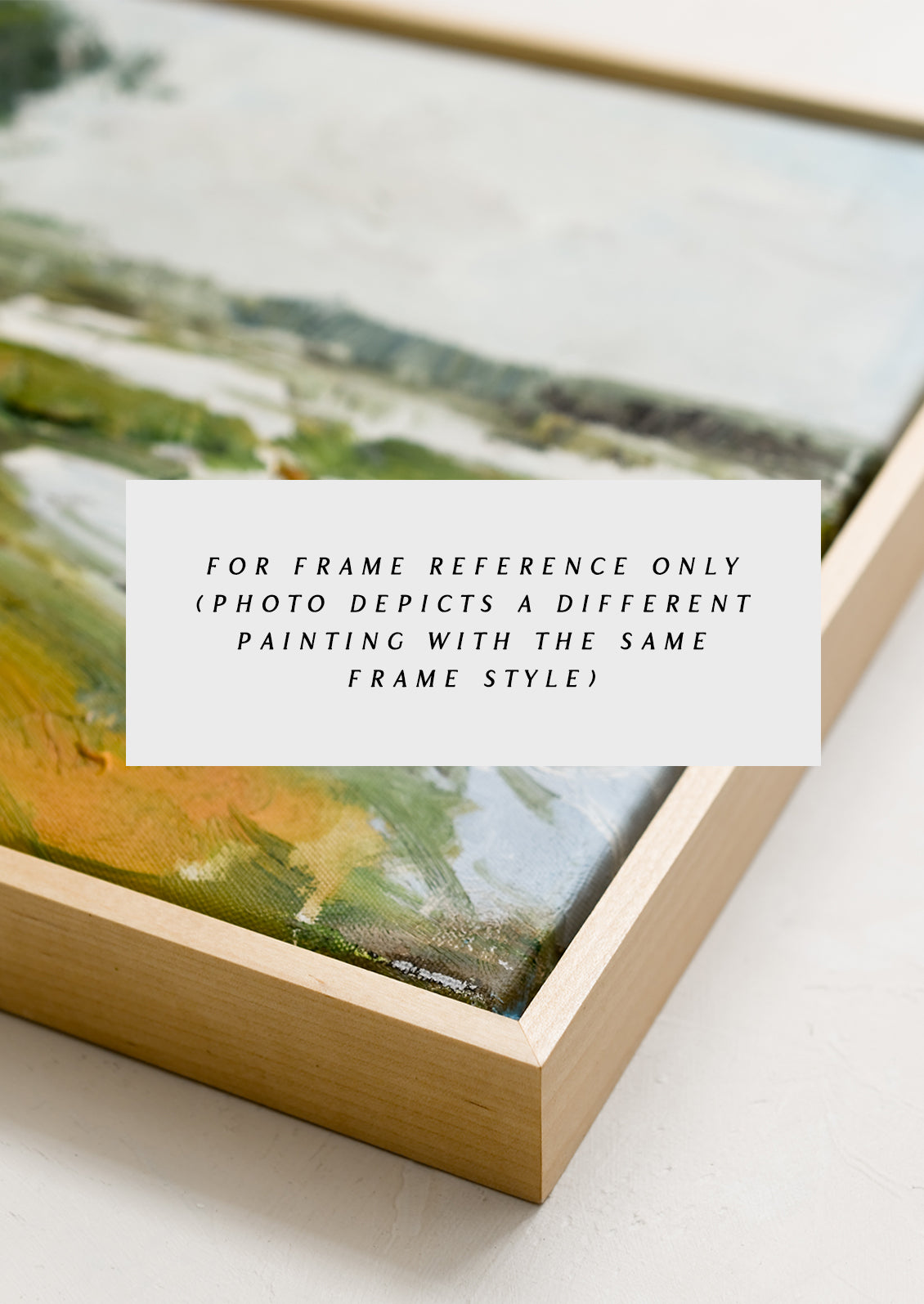 A framed original oil painting of a colorful meadow in the countryside.