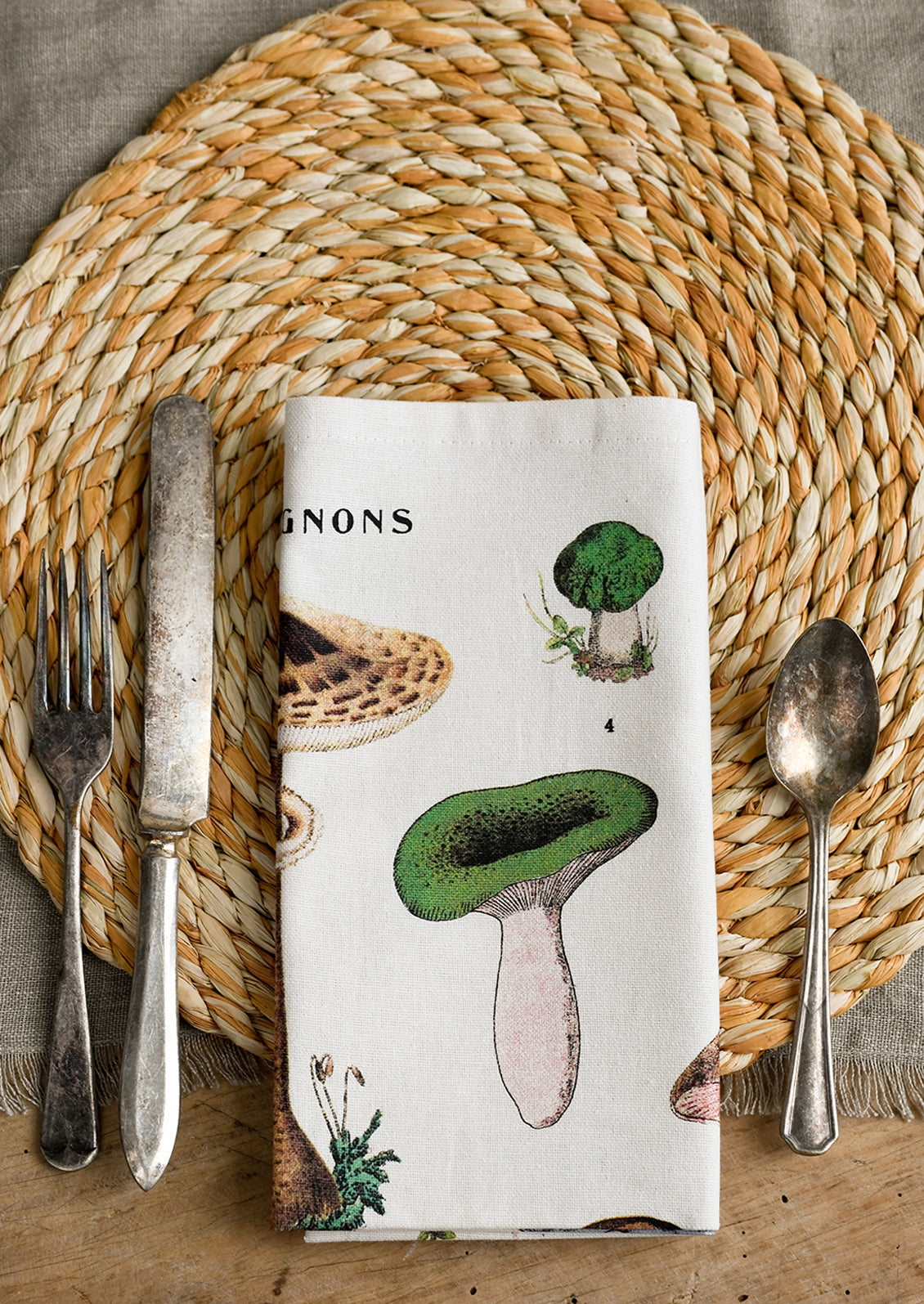 A round woven raffia placemat in natural and sunflower.