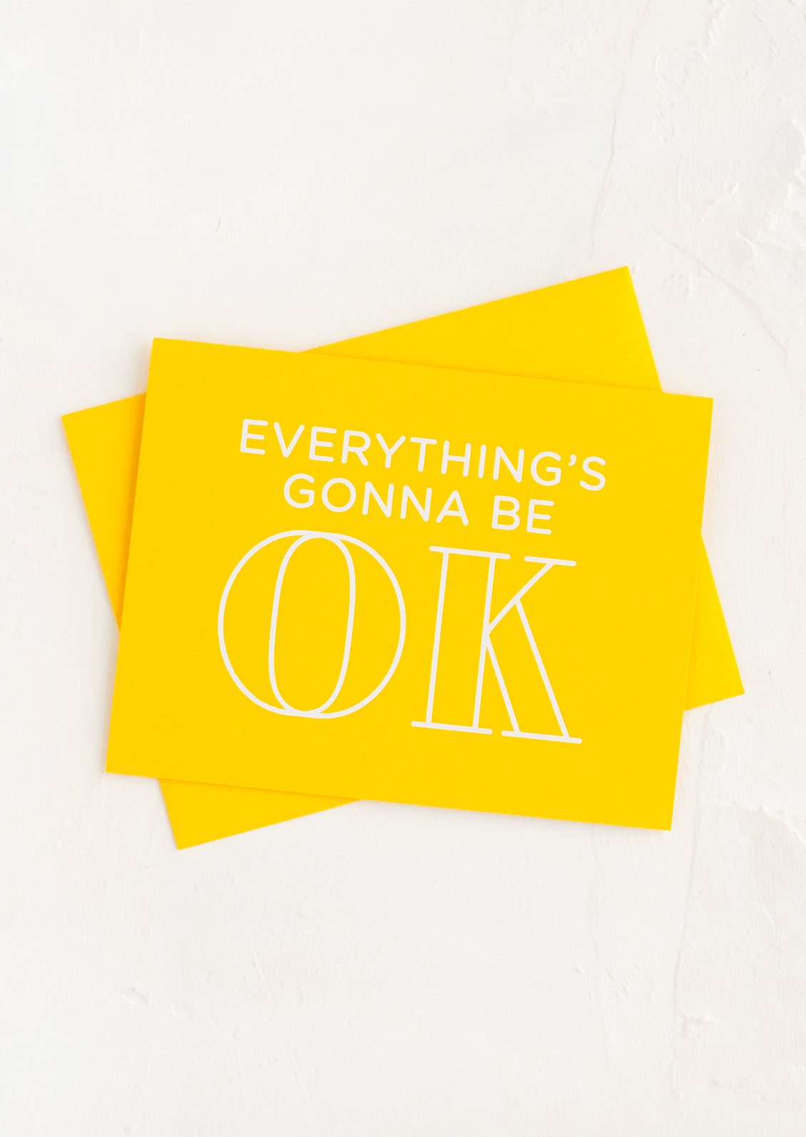 Yellow card with write text reading "Everything's gonna be OK".