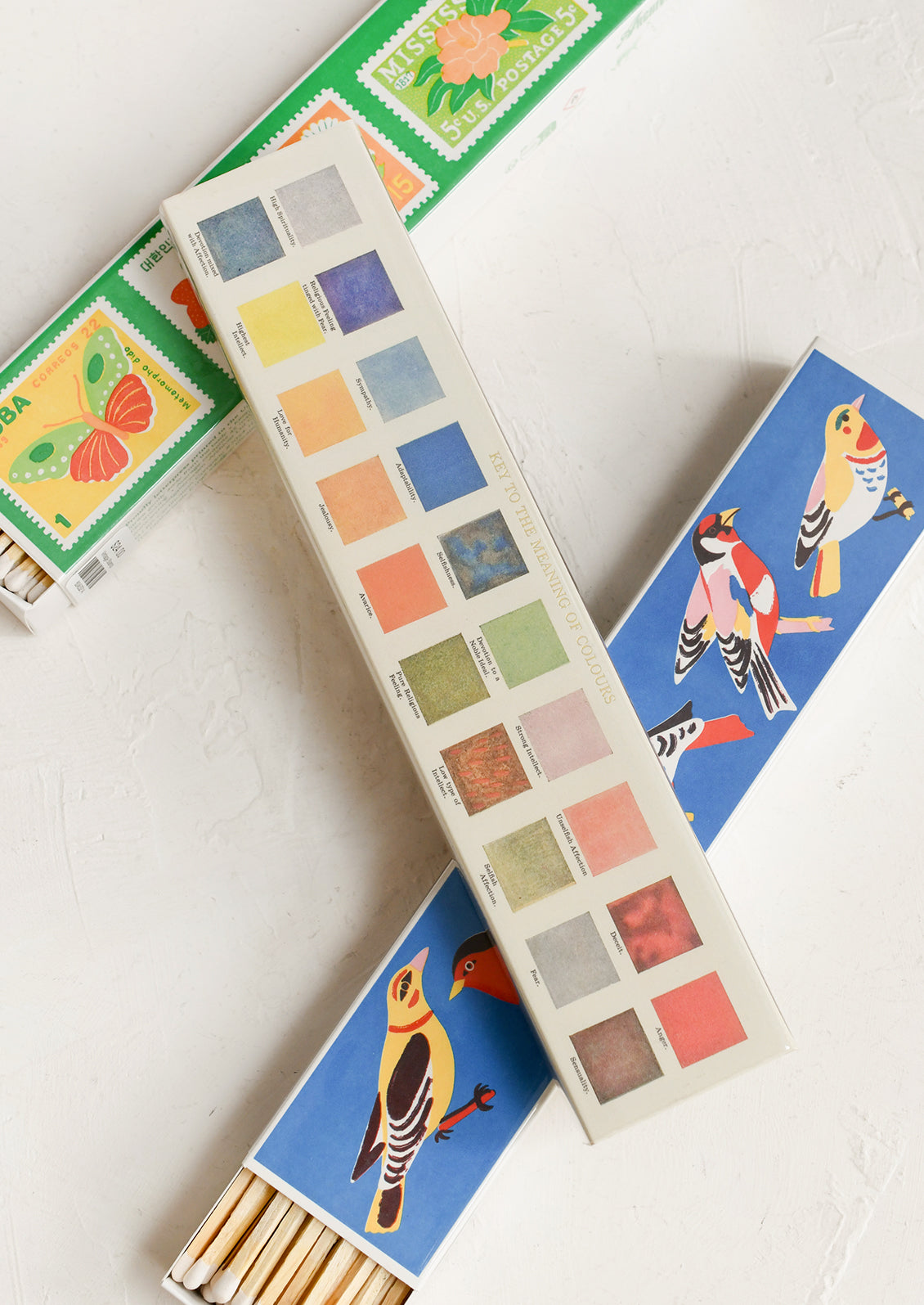 A flat-lay view of long matchboxes in assorted designs.