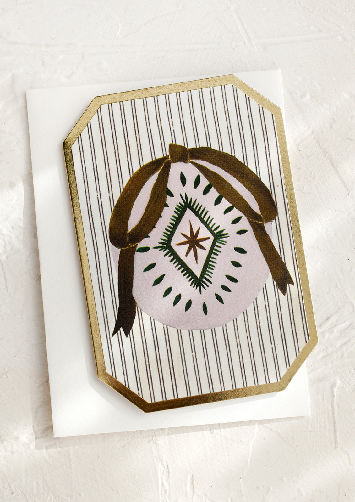 A mini die cut greeting card with ornament illustration.