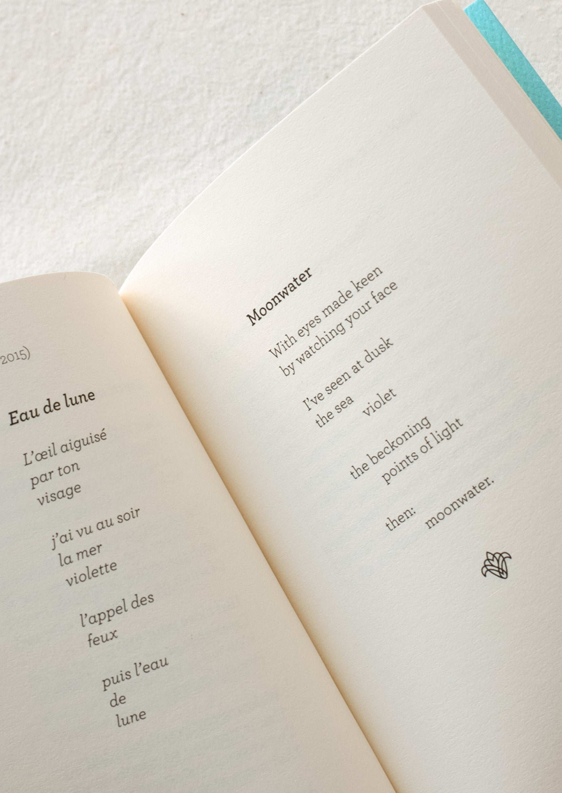Small blue book with red writing featuring the text "french love poems".