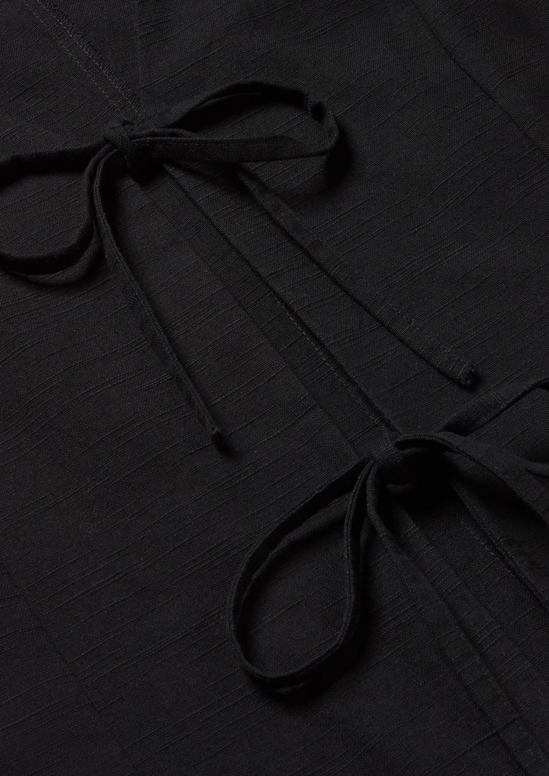 A black sleeveless top with front ties.