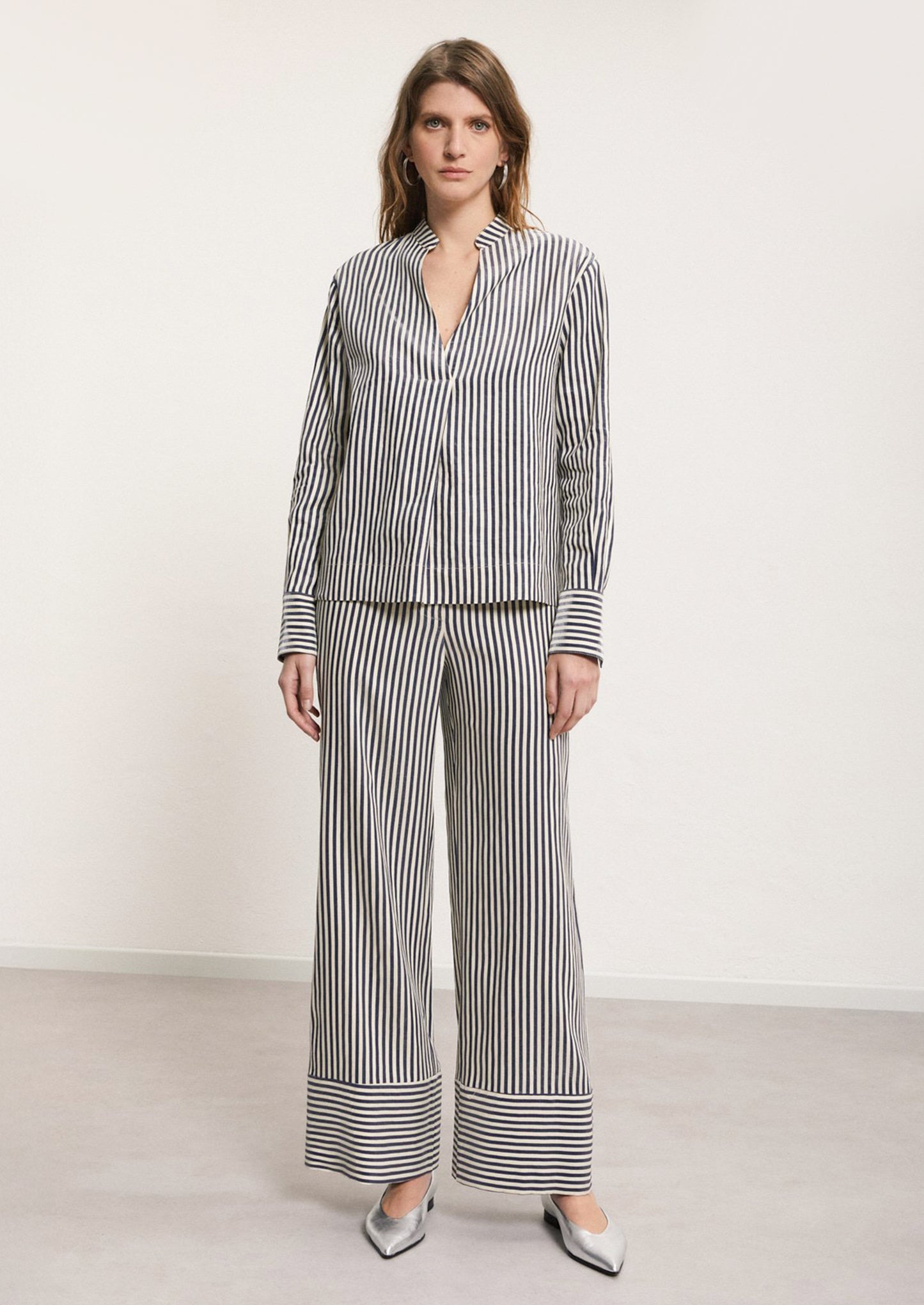 A woman wearing a matching striped top and bottom.