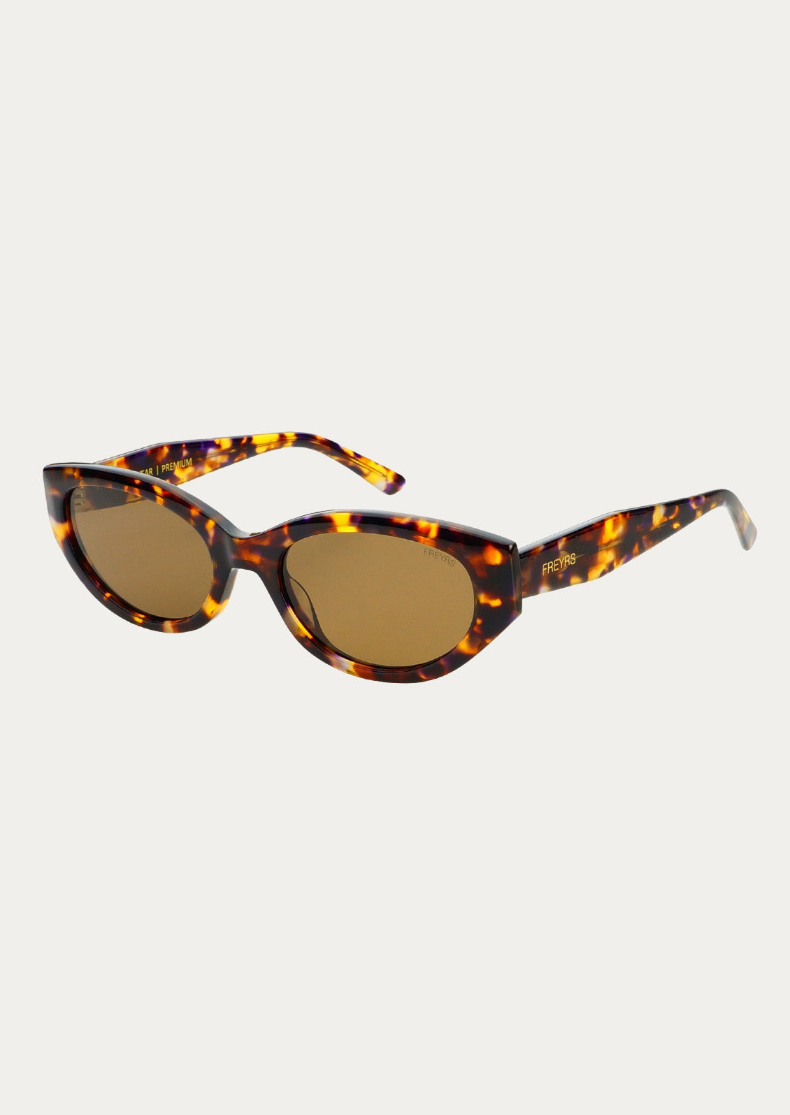 A pair of cat eye sunglasses with marbled tortoise frames and brown tinted lenses.
