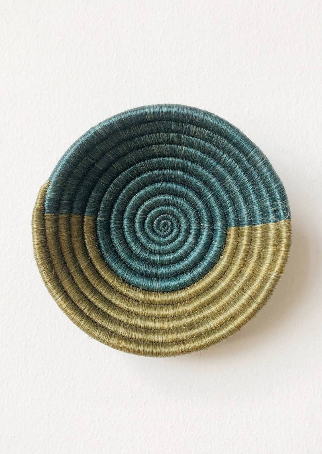 A woven sweetgrass bowl in lagoon and olive.
