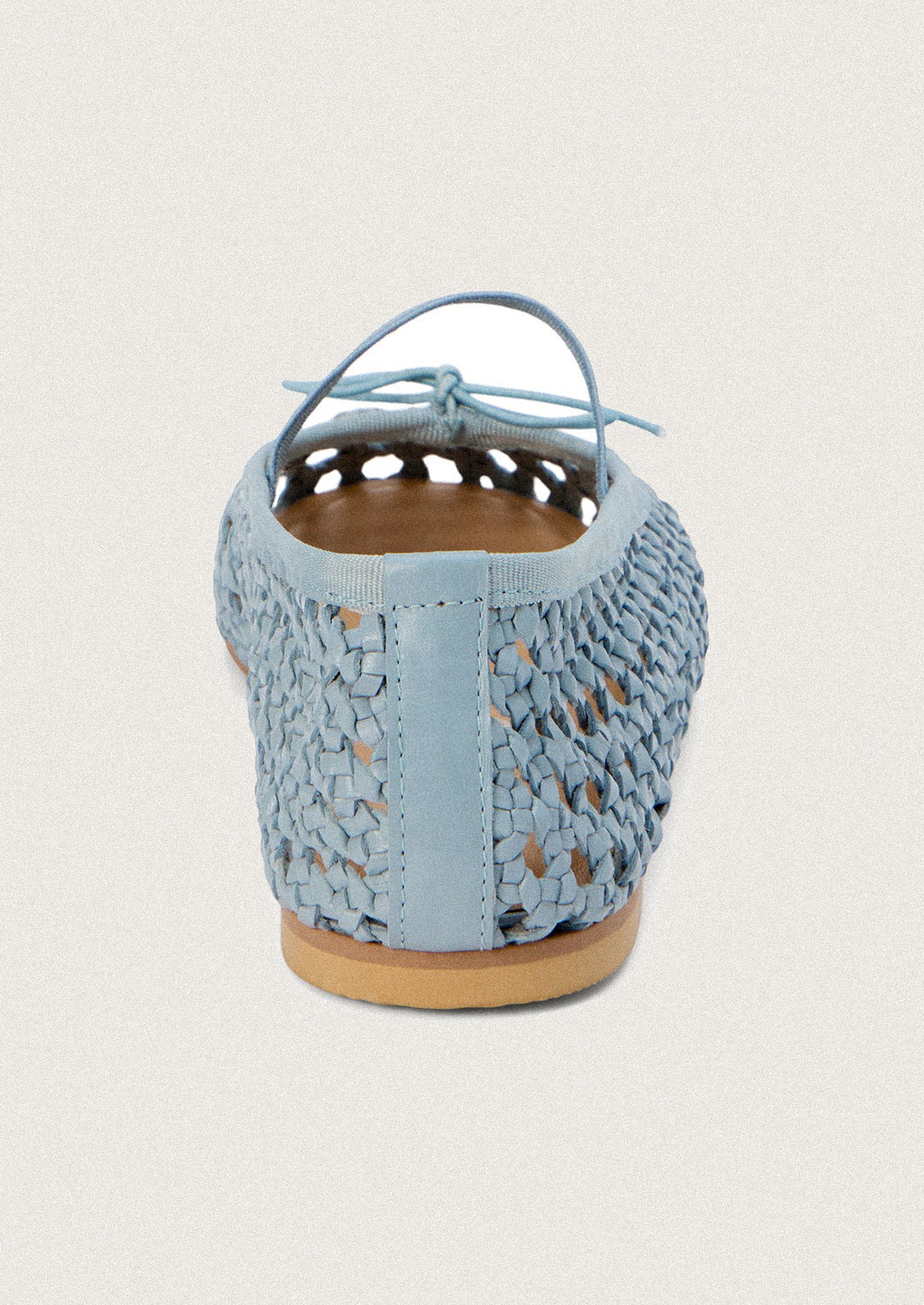 A pair of open weave leather ballet flats in powder blue.