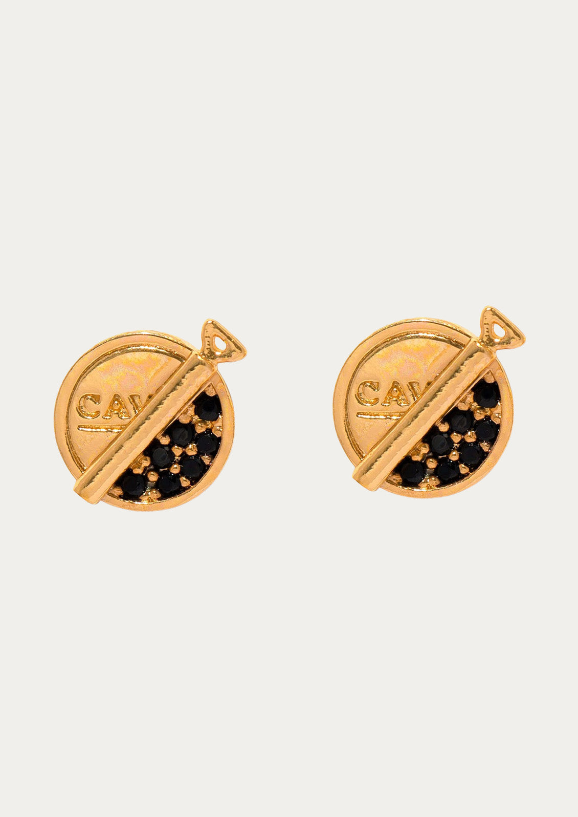 A pair of gold plated stud earrings in the shape of caviar cans with black and gold gems imitating caviar on a white background.