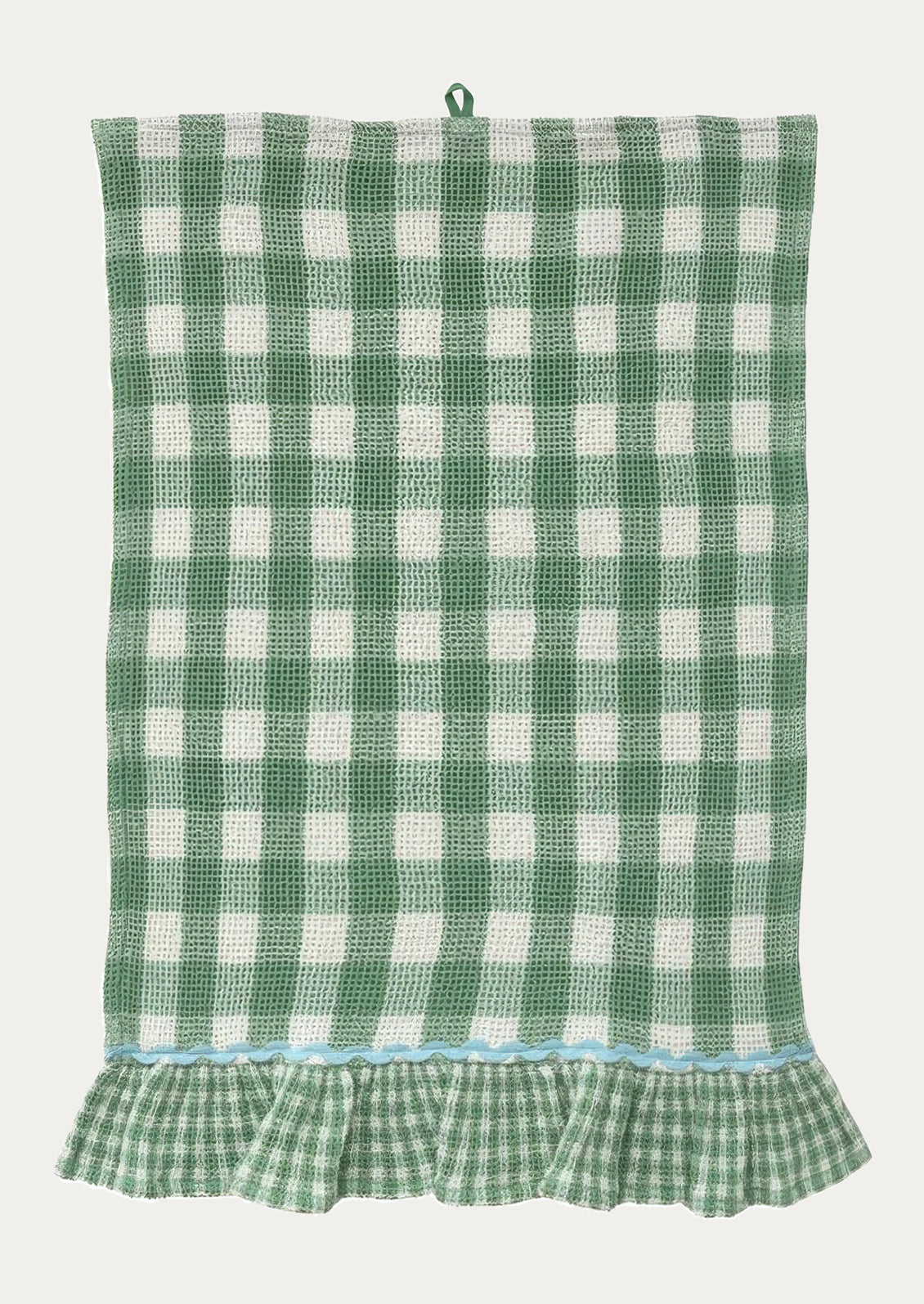 A waffle textured tea towel in green gingham pattern, ruffle at bottom in smaller scale gingham with contrast ric rac trim.
