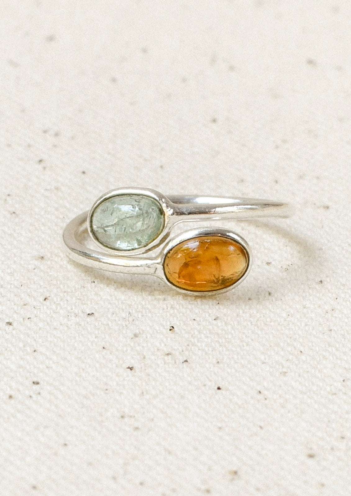 A sterling silver ring with a wrapped design and  two stacked natural tourmaline stones.