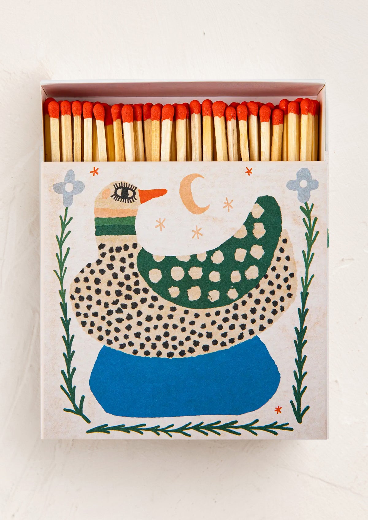 An oversized box of matches. Matches have red tips, and the box has a playful illustrative duck design.