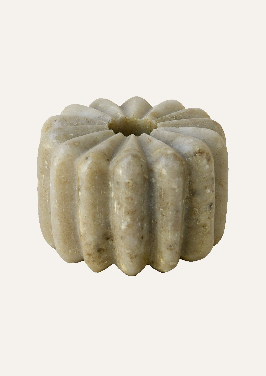 A fluted marble taper holder in tan color.