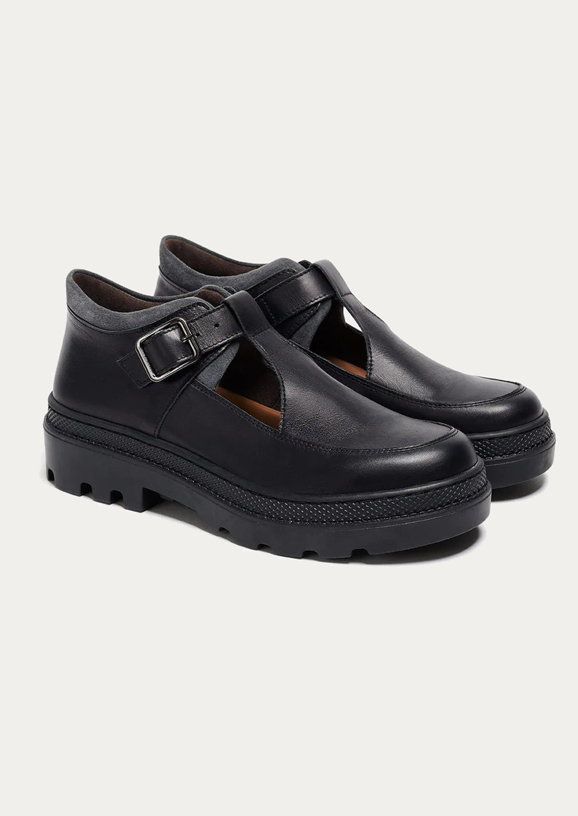 Pair of black shoes with a buckle on a white background