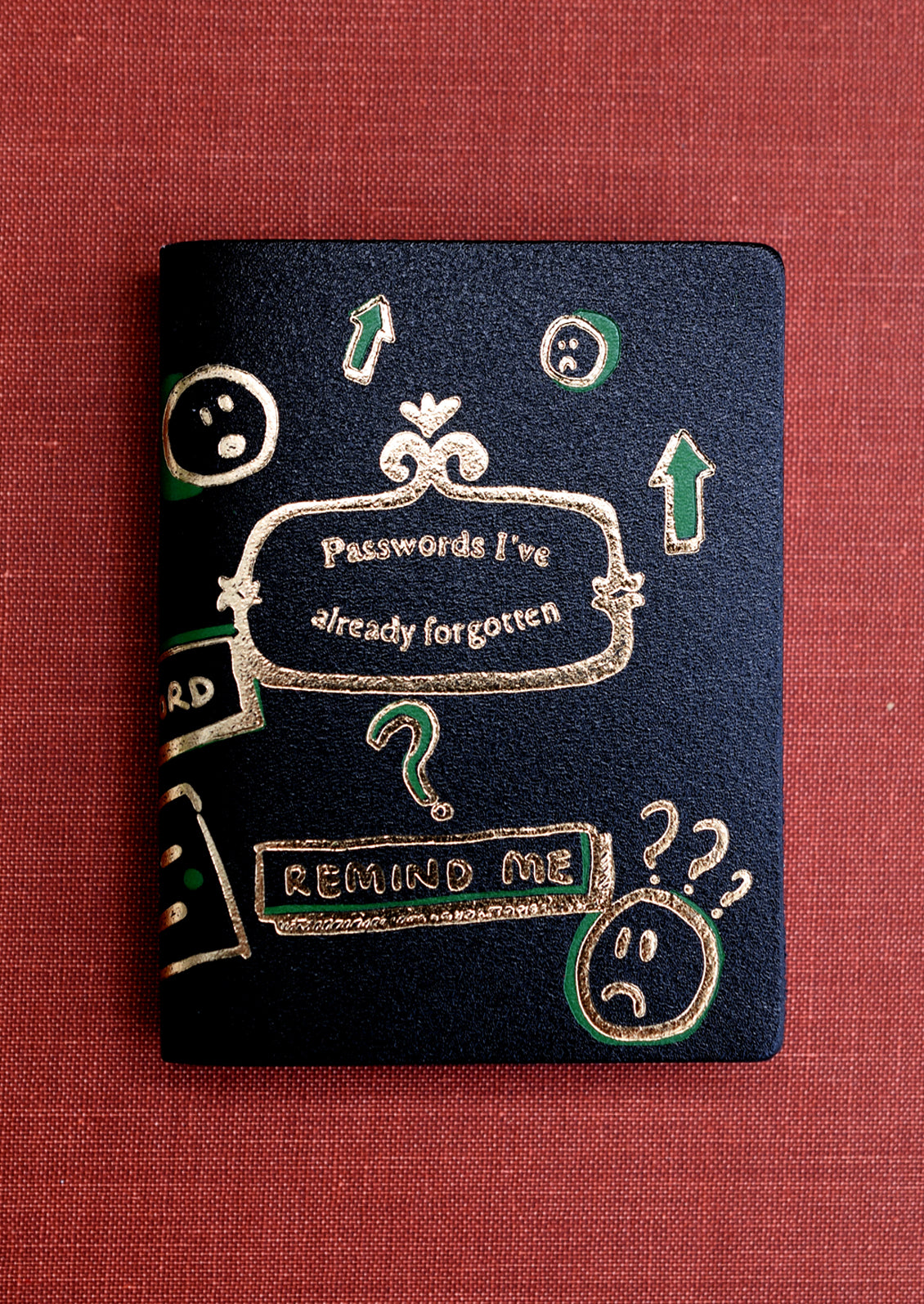 A black notebook reading "Passwords I've Already Forgotten" on cover.