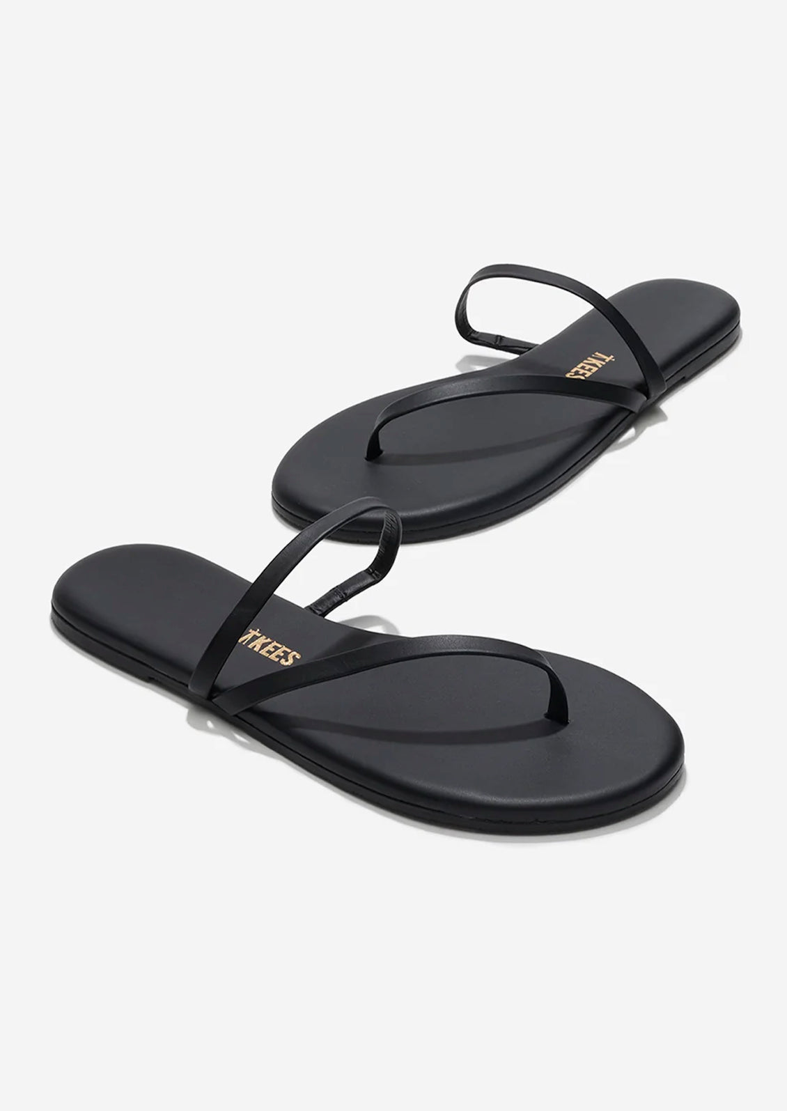 A pair of black leather strappy sandals by TKEES.
