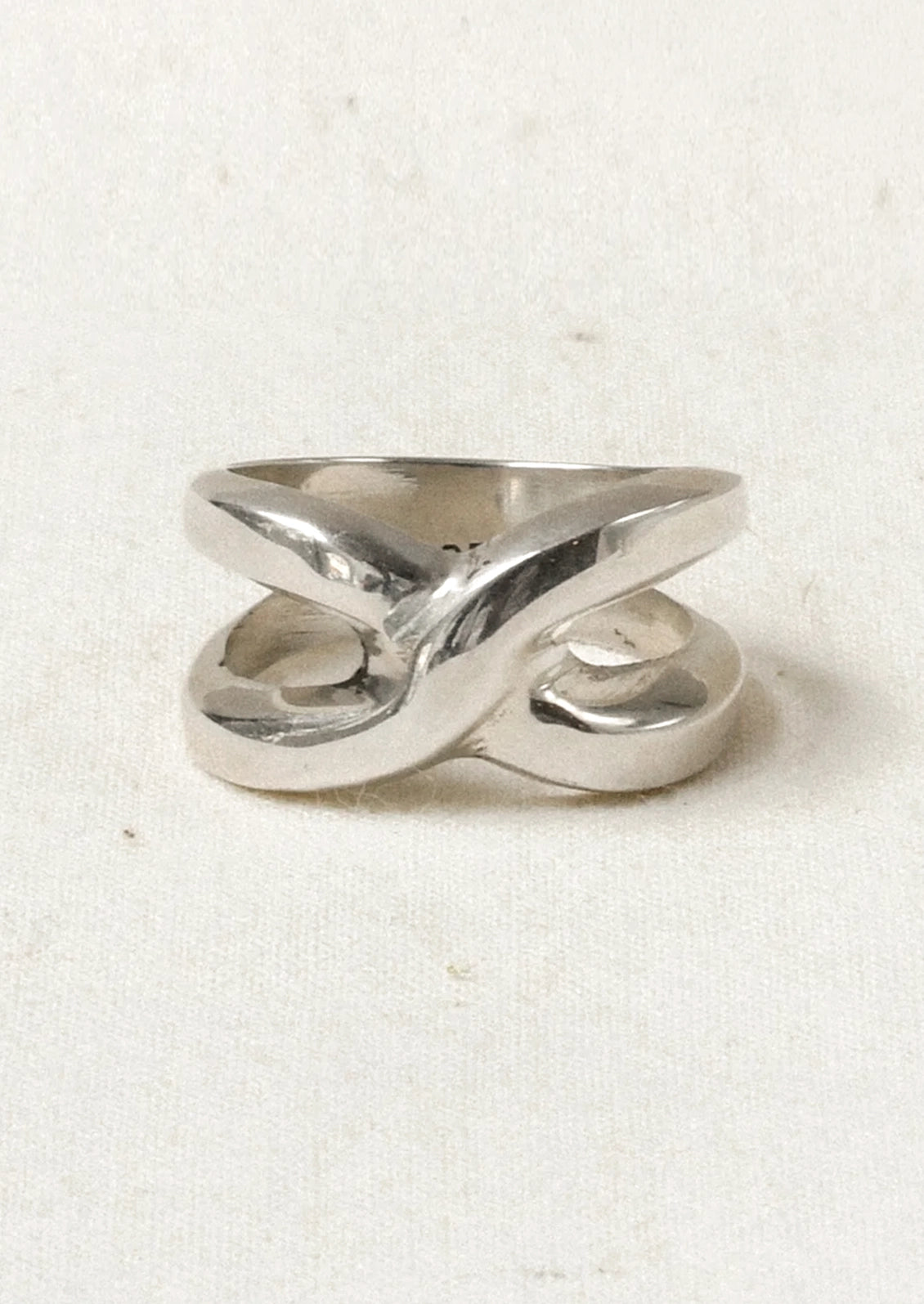 A chunky sterling silver ring with a knot-like design.