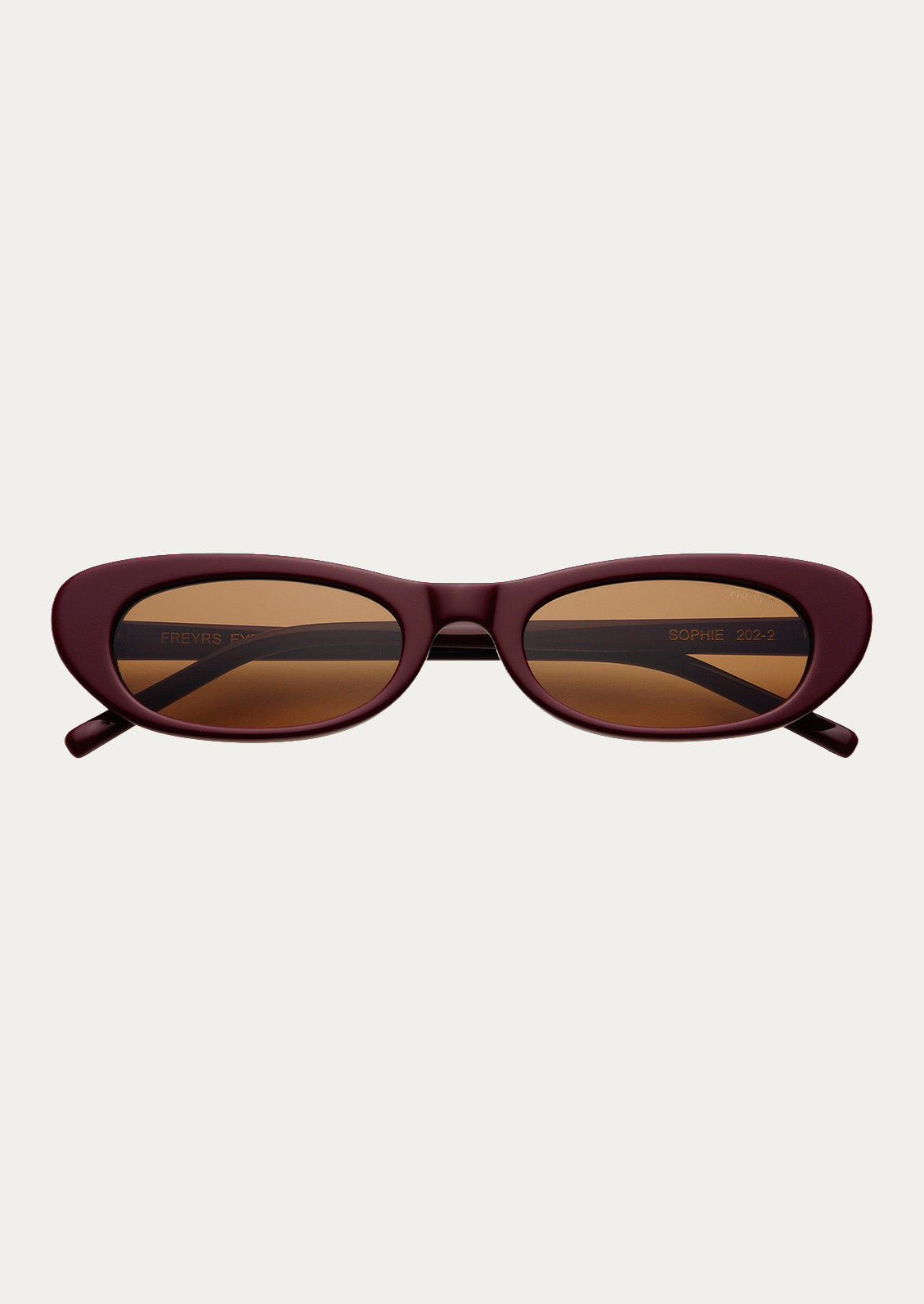 A pair of cat eye sunglasses with burgundy frames and brown tinted lenses.