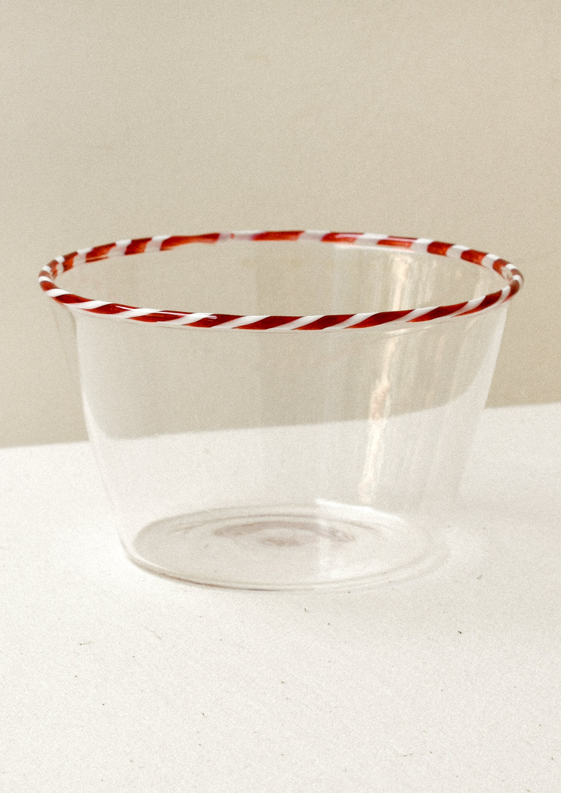 Clear glass blow with a red striped rim