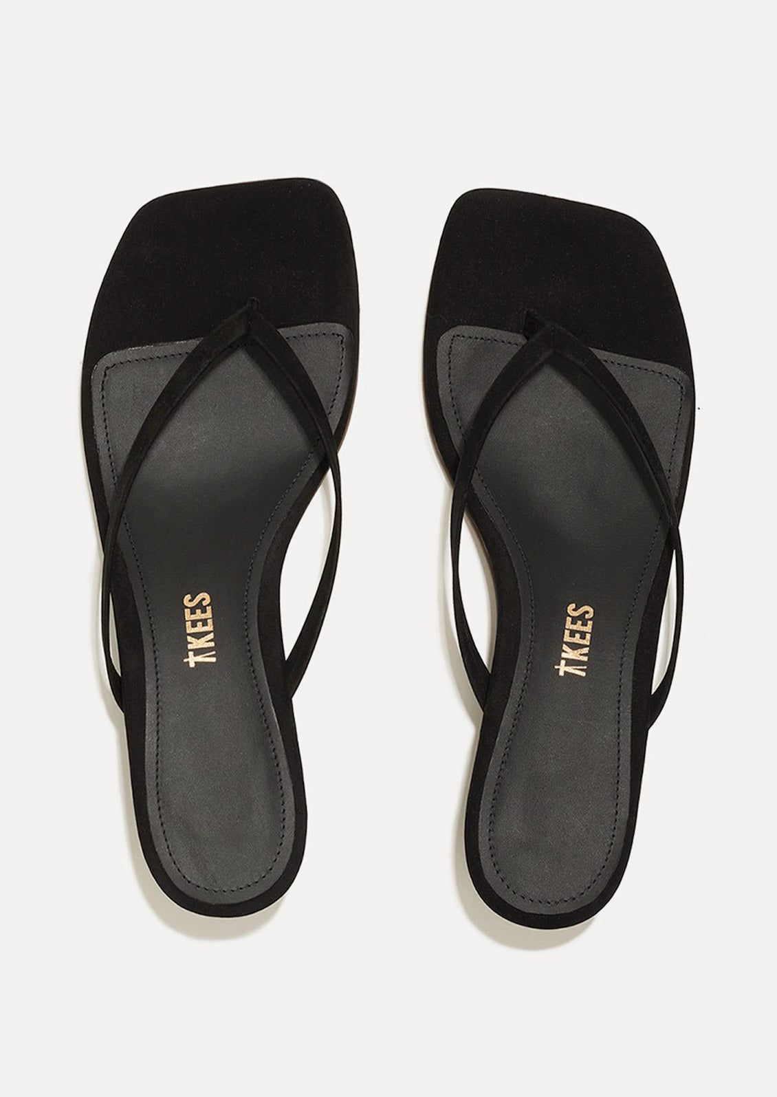 A pair of black suede kitten heel sandals with a square toe by TKEES.