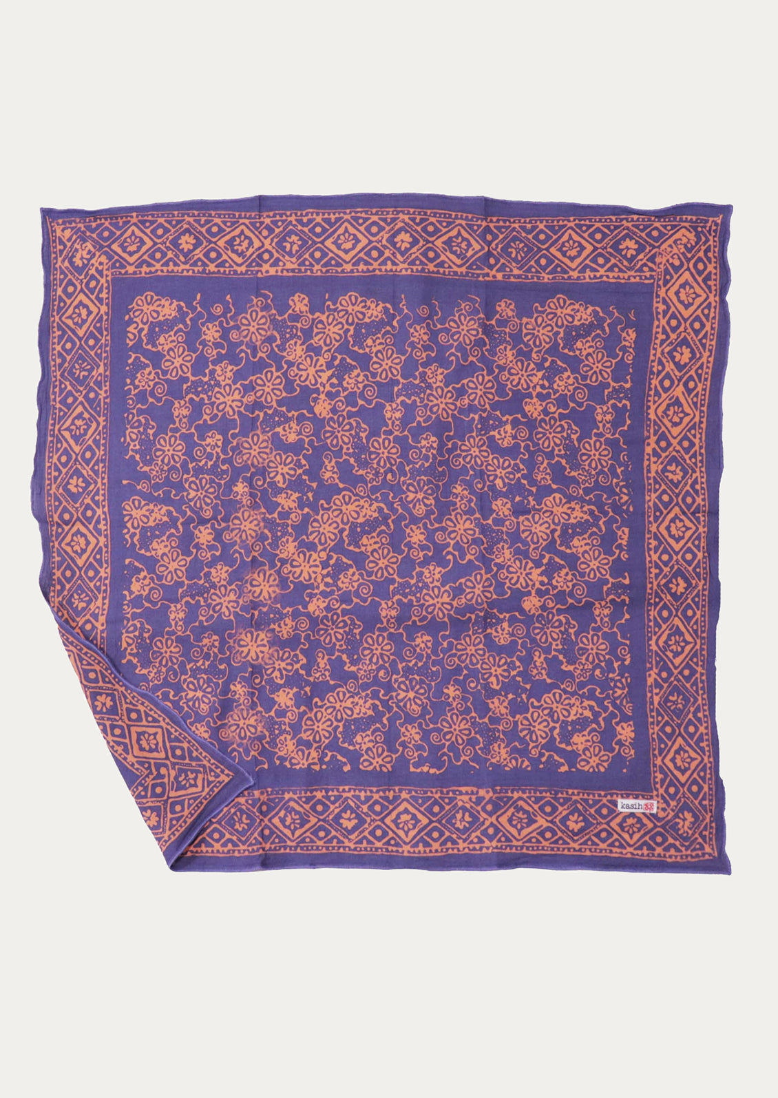 A square purple scarf with an intricate peach floral pattern and a matching geometric border.