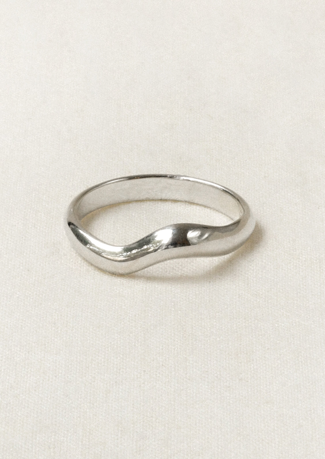 A sterling silver ring with a wavy design.