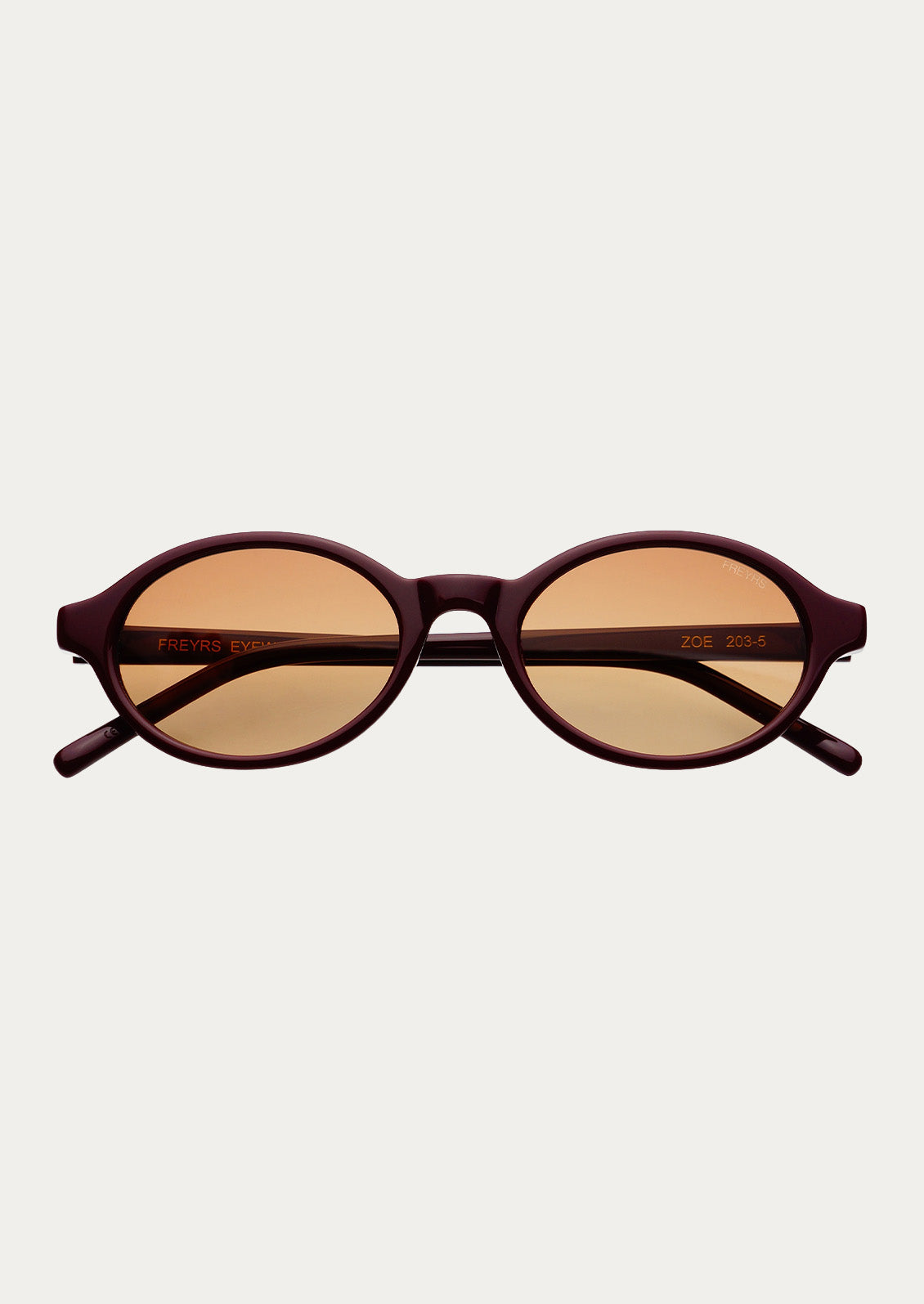 A pair of round oval sunglasses with a burgundy frame and light brown tinted lenses.
