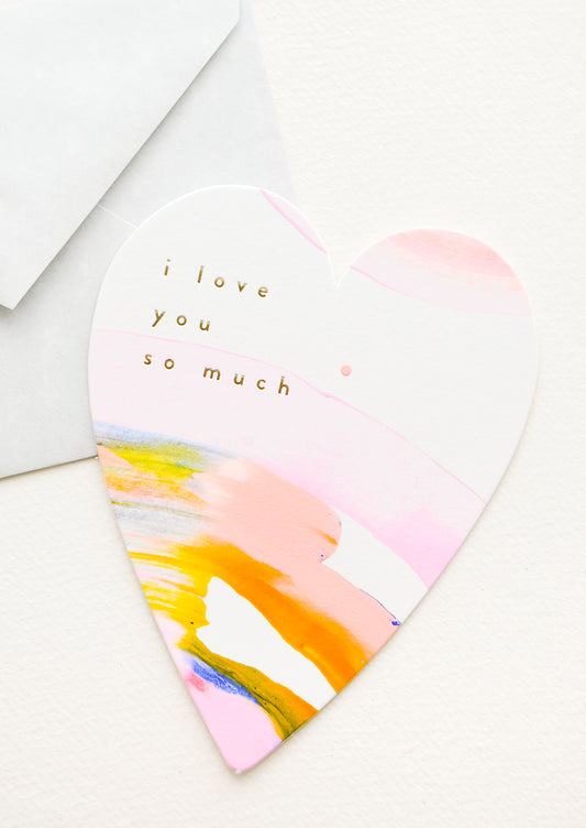 Heart-shaped greeting card with hand-painted multicolor swirl and gold text reading "I Love You So Much"