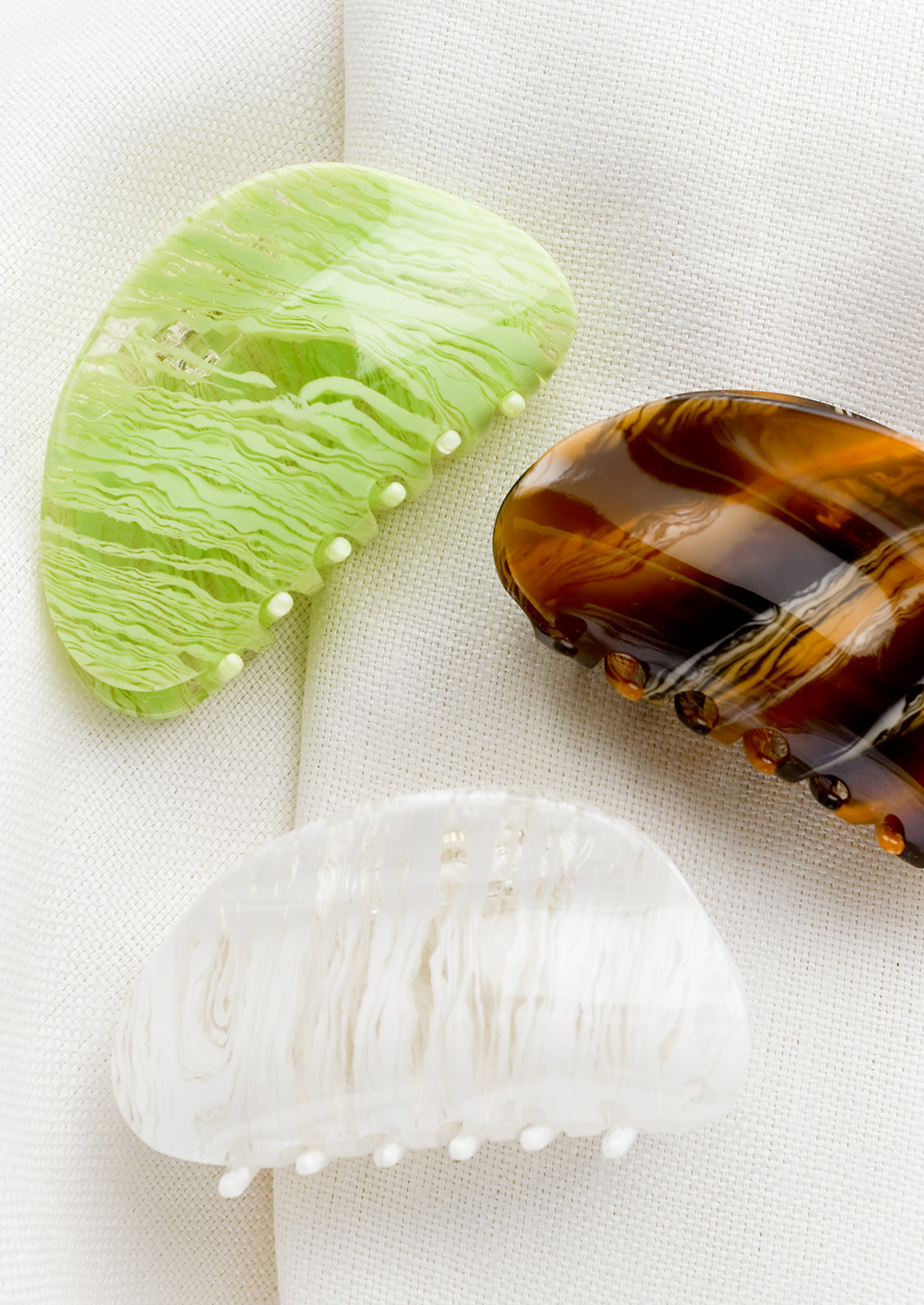 Asymmetric, curved hair claws in assorted colors.