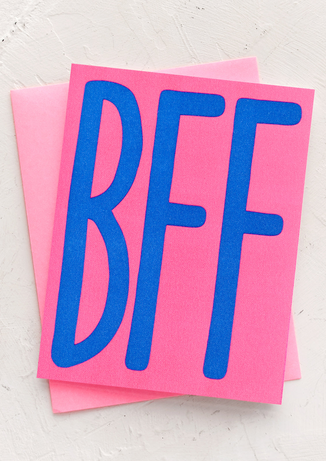 A neon pink card with big blue "BFF" letters.