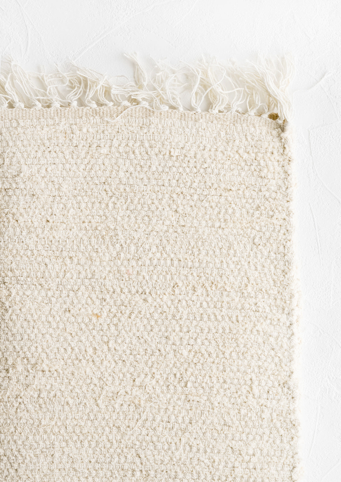 A textured cotton rug in natural undyed.