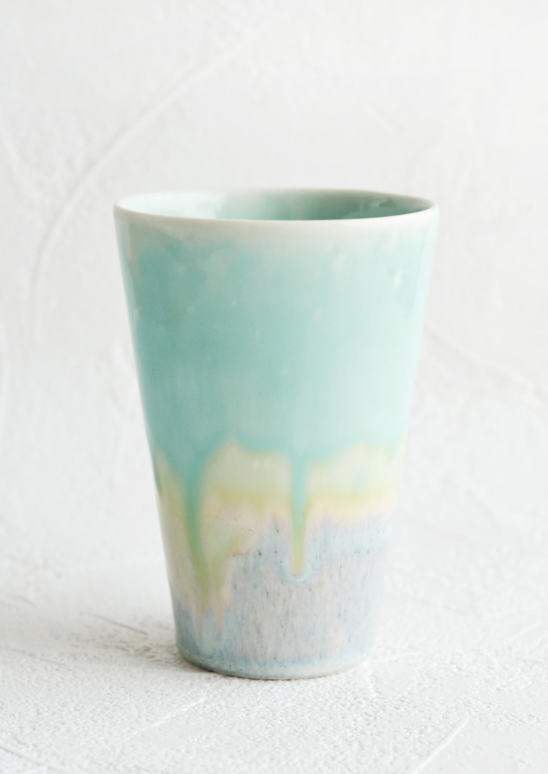 A ceramic cup in aqua.