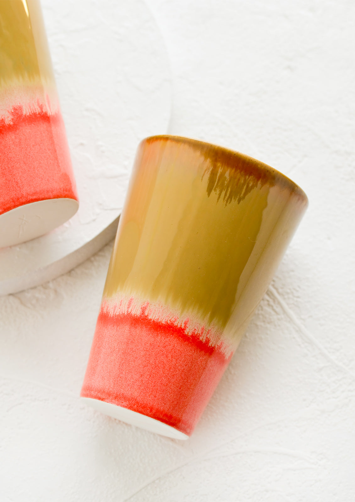 A ceramic cup in brown and pink.