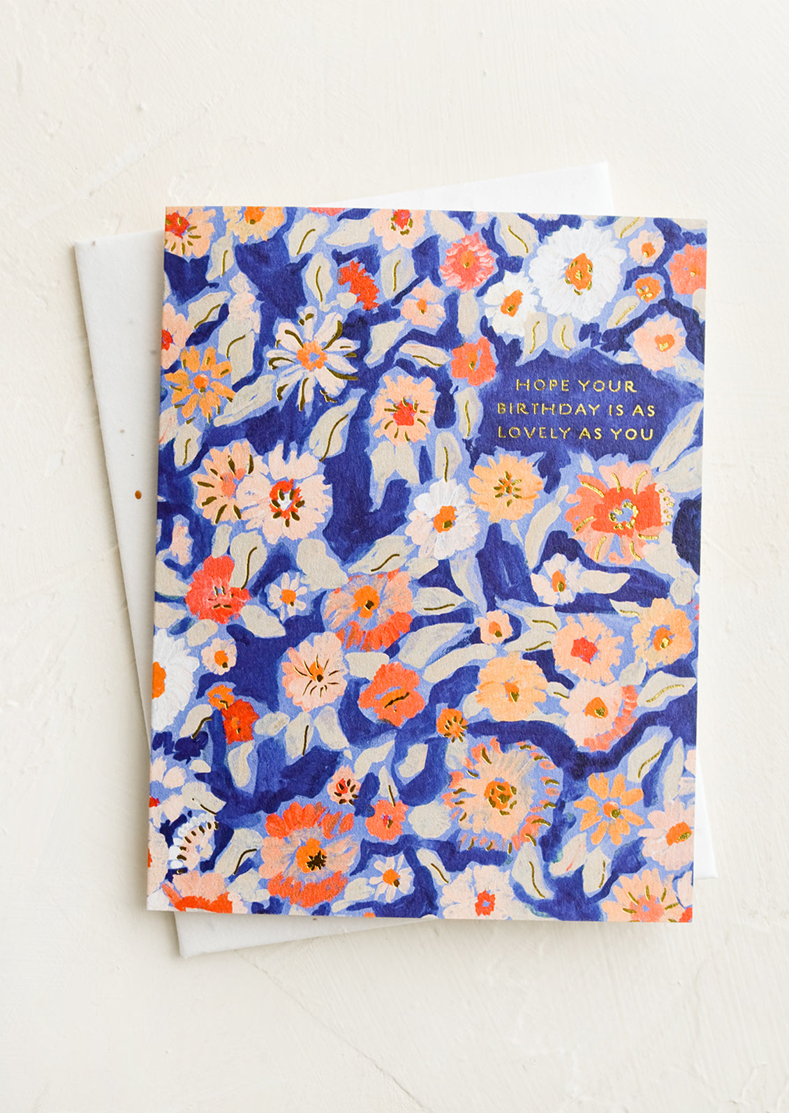 A birthday greeting card with blue floral background.