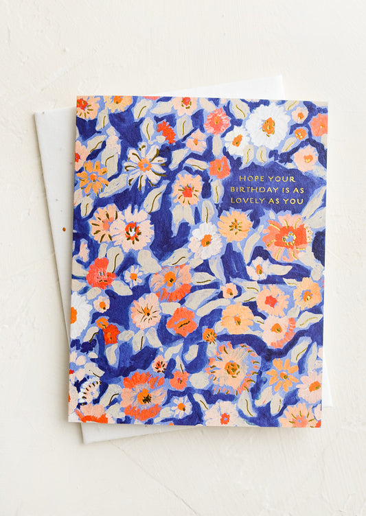 A birthday greeting card with blue floral background.