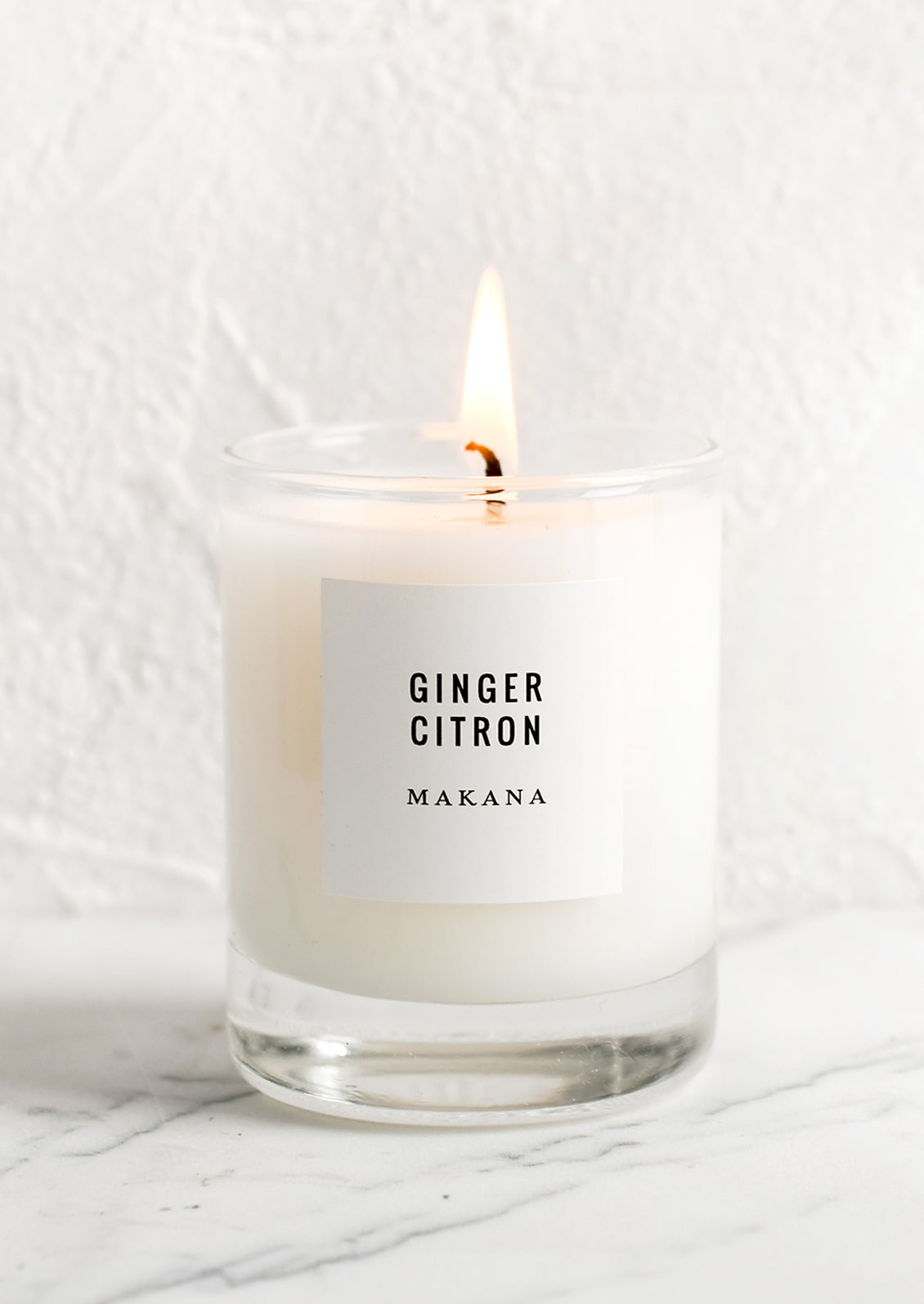 A votive candle in glass container.