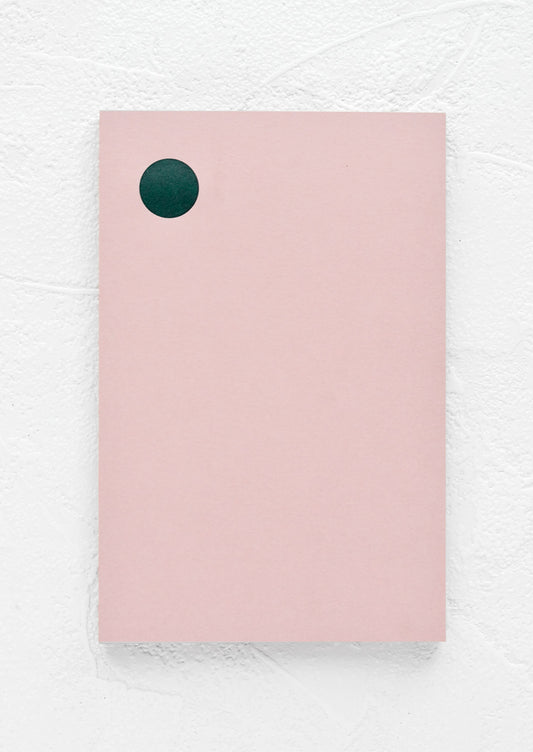 A pink notepad with green dot at top left corner.