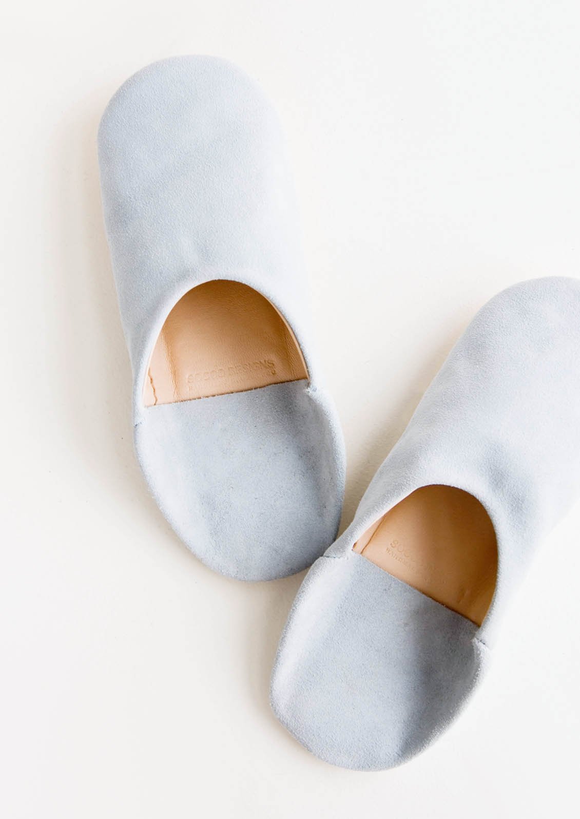 Pair of suede house slippers in baby blue