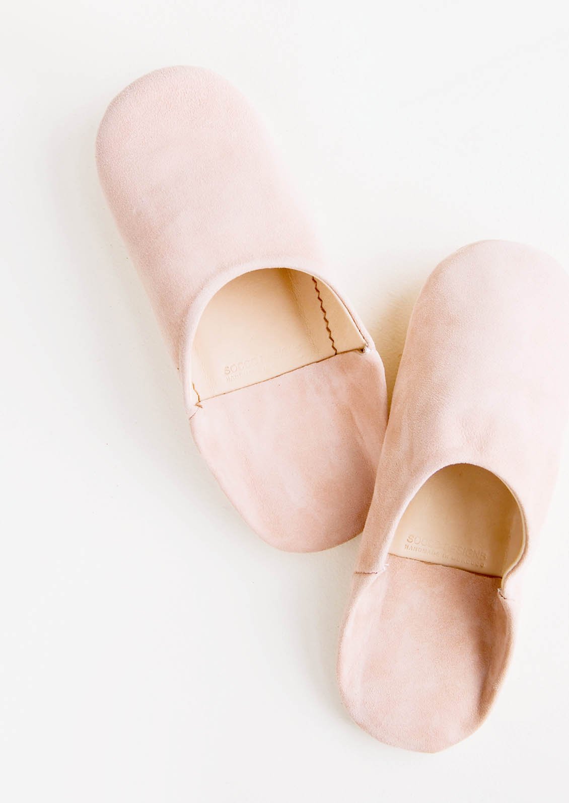 Pair of suede house slippers in blush pink