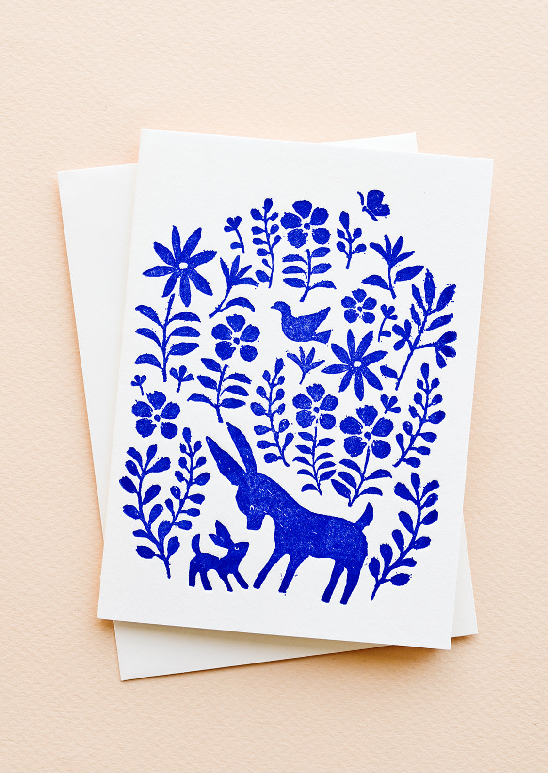 A white greeting card with blue otomi print on front and a plain white envelope.