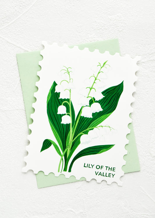 Diecut greeting card in the shape of a postage stamp, printed graphic of Lily of the Valley floral.