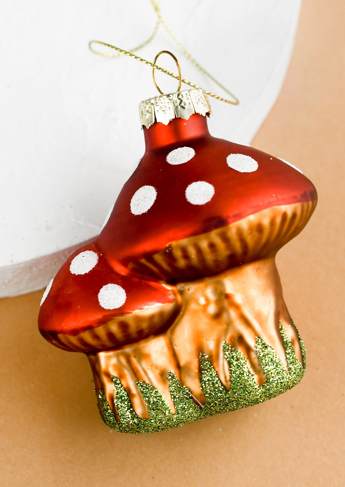A glass ornament of two agaric mushrooms.